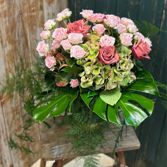 Pink bouquet in vase of hydrangea and pink spray roses